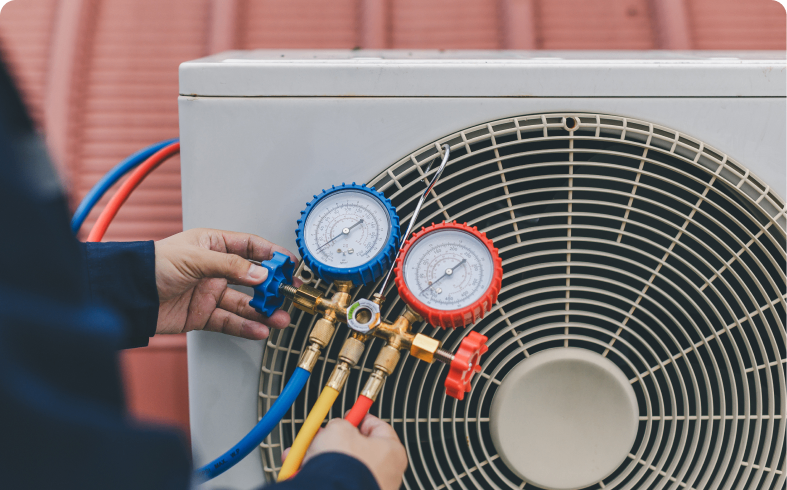 Technician checking air conditioning unit pressure.