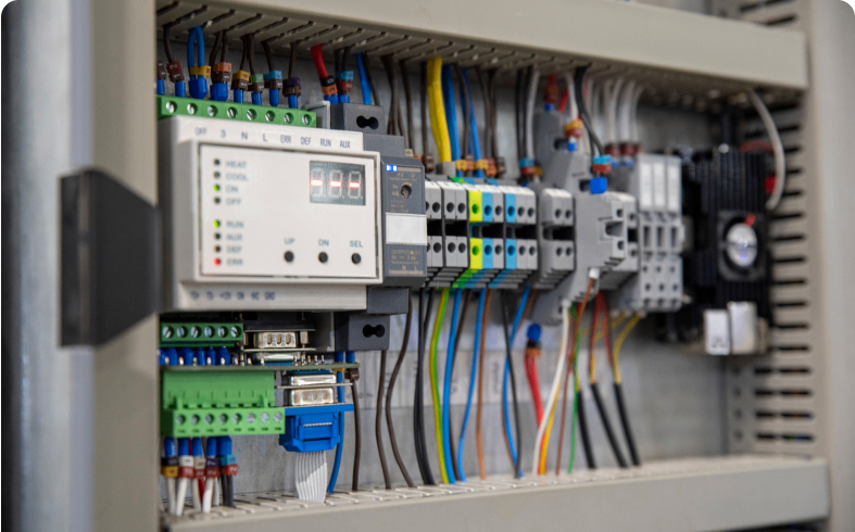 Electrical control panel with various wires connected.