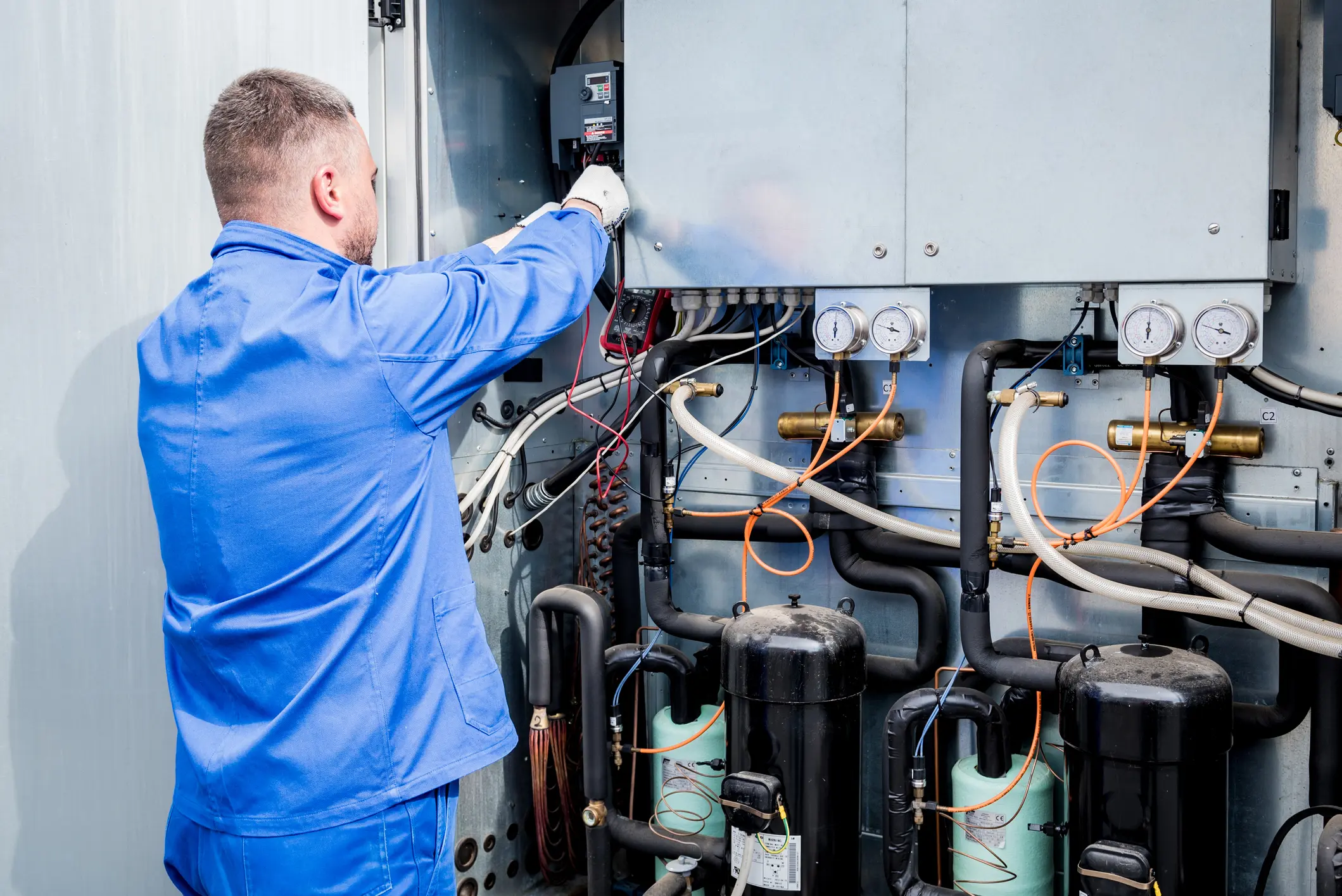 Technician working on industrial electrical equipment.