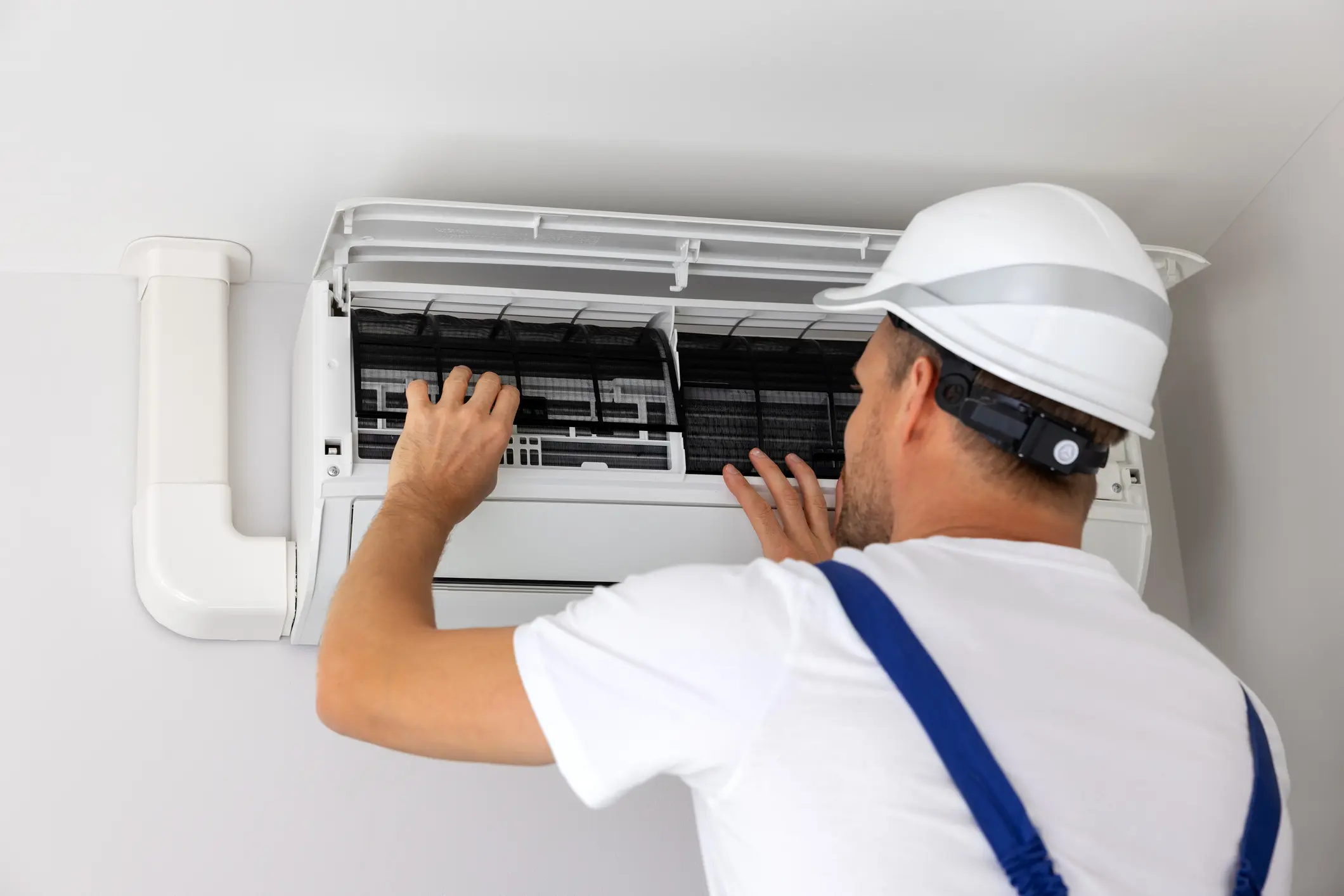 Technician servicing an air conditioning unit.